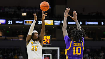 Jan 7, 2025; Columbia, Missouri, USA; Missouri Tigers guard Mark Mitchell (25) shoots against LSU Tigers forward Daimion Collins (10) during the first half at Mizzou Arena. Mandatory Credit: Jay Biggerstaff-Imagn Images