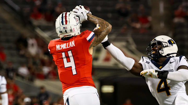 Oct 26, 2024; Tucson, Arizona, USA; Arizona Wildcats wide receiver Tetairoa McMillan (4) catches a long pass while West Virginia Mountaineers linebacker Trey Lathan (4) fails to defend against him during the fourth quarter at Arizona Stadium. Mandatory Credit: Aryanna Frank-Imagn Images