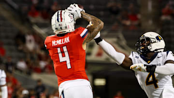 Oct 26, 2024; Tucson, Arizona, USA; Arizona Wildcats wide receiver Tetairoa McMillan (4) catches a long pass while West Virginia Mountaineers linebacker Trey Lathan (4) fails to defend against him during the fourth quarter at Arizona Stadium.