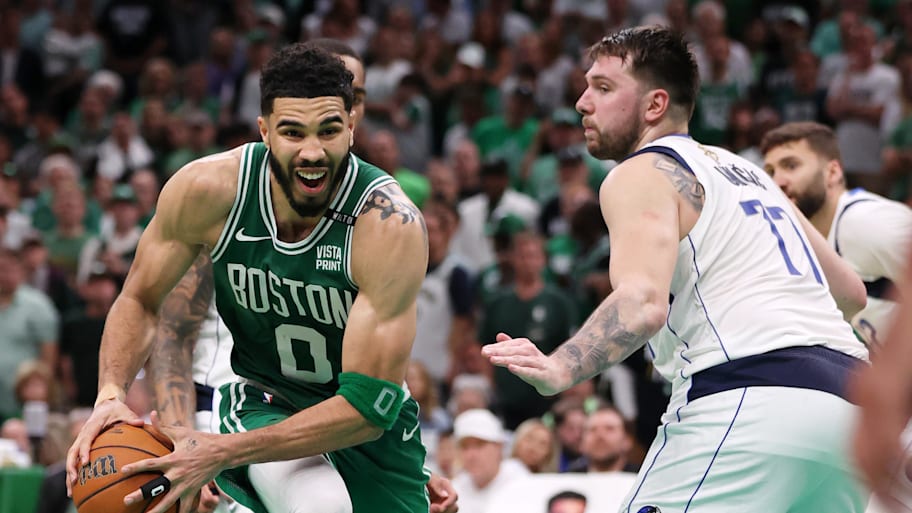 Boston Celtics forward Jayson Tatum goes against Dallas Mavericks guard Luka Doncic in the 2024 NBA Finals.