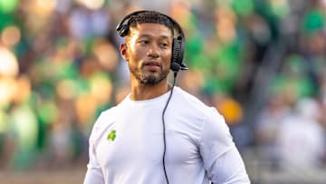 Oct 4, 2025; South Bend, Indiana, USA; Notre Dame head football coach Marcus Freeman adjusts his radio against the Boise State Broncos at Notre Dame Stadium. 