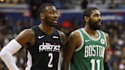 Dec 12, 2018; Washington, DC, USA; Washington Wizards guard John Wall (2) talks with Boston Celtics guard Kyrie Irving (11) in the fourth quarter at Capital One Arena. The Celtics won 130-125 in overtime. Mandatory Credit: Geoff Burke-Imagn Images