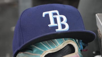 Sep 26, 2025; Toronto, Ontario, CAN; The hat and glove of Tampa Bay Rays third baseman Junior Caminero (13) in the dugout during the game against the Toronto Blue Jays at Rogers Centre. 