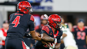 Oct 3, 2025; San Diego, California, USA; San Diego State Aztecs quarterback Jayden Denegal (4) hands the ball off to running back Christian Washington (23) during the first half against the Colorado State Rams at Snapdragon Stadium. 