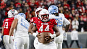 Nov 29, 2025; Raleigh, North Carolina, USA;  NC State Wolfpack defensive tackle Brandon Cleveland (44) reacts to his tackle during the first half of the game against North Carolina Tar Heels at Carter-Finley Stadium.  Mandatory Credit: Jaylynn Nash-Imagn Images