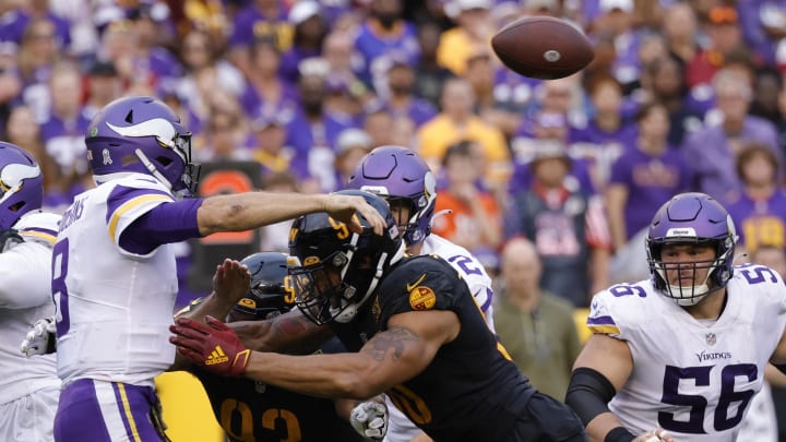 Nov 6, 2022; Landover, Maryland, USA; Minnesota Vikings quarterback Kirk Cousins (8) is hit by Washington Commanders defensive end Montez Sweat (90) while passing the ball during the fourth quarter at FedExField. Mandatory Credit: Geoff Burke-USA TODAY Sports