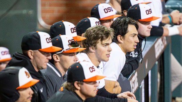 Oregon State players watch their team compete against San Diego during an NCAA college baseball game at Goss Stadium.