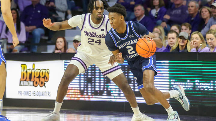 Feb 24, 2024; Manhattan, Kansas, USA; Brigham Young Cougars guard Jaxson Robinson (2) dribbles against Kansas State Wildcats forward Arthur Maluma (24) during the first half at Bramlage Coliseum. Mandatory Credit: Scott Sewell-USA TODAY Sports