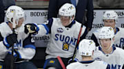 Team Finland coach Antti Pennanen behind forward Patrik Laine in the first period during the 4 Nations Face-Off vs. Team Sweden.