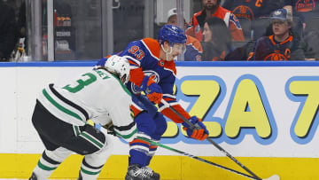 Edmonton Oilers forward Ryan Nugent-Hopkins (93) and Dallas Stars defensemen Chris Tanev (3) battle along the boards for a loose puck