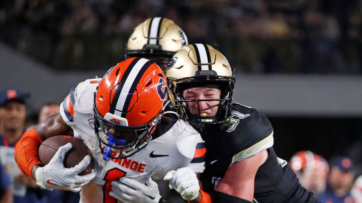 Syracuse Orange LeQuint Allen Jr. (1) is tackled by Purdue Boilermakers defensive back Dillon Thieneman (31) during the NCAA football game, Saturday, Sept. 16, 2023, at Ross-Ade Stadium in West Lafayette, Ind. Syracuse Orange won 35-20.