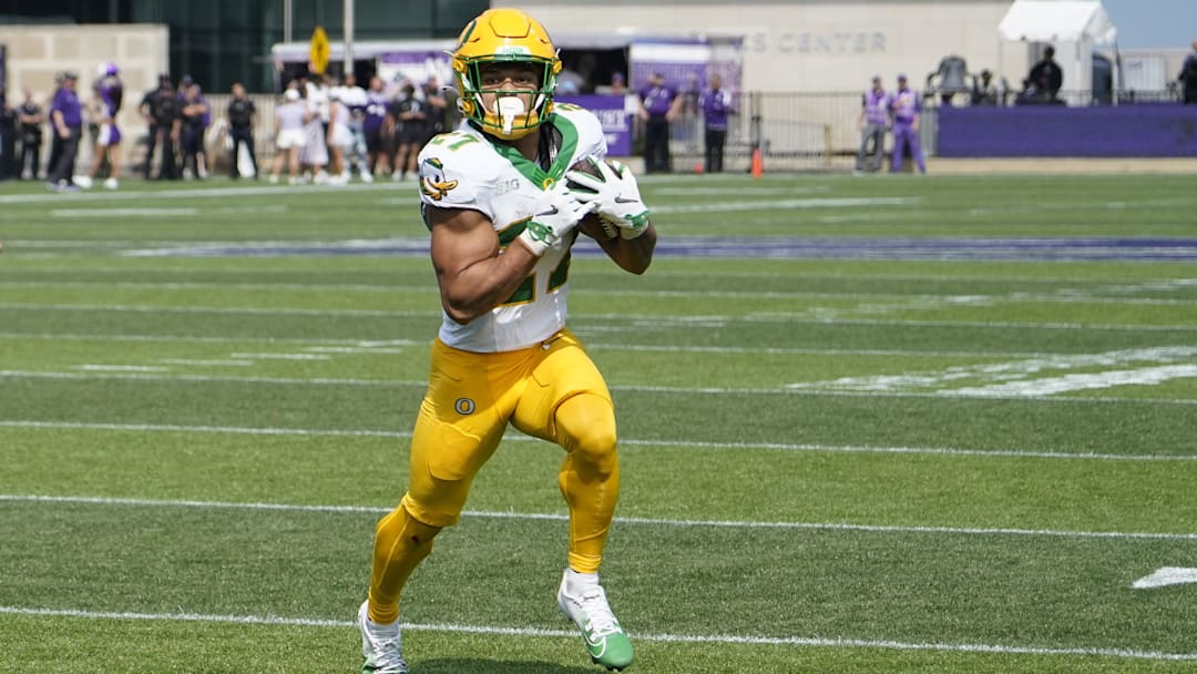 Sep 13, 2025; Evanston, Illinois, USA; Oregon Ducks running back Jayden Limar (27) runs for a touchdown against the Northwestern Wildcats during the first half.
