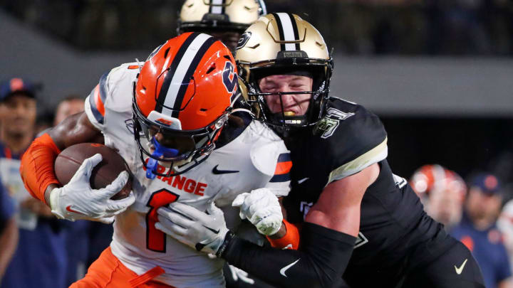 Syracuse Orange LeQuint Allen Jr. (1) is tackled by Purdue Boilermakers defensive back Dillon Thieneman (31) 