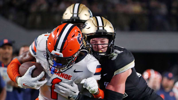 Syracuse Orange LeQuint Allen Jr. (1) is tackled by Purdue Boilermakers defensive back Dillon Thieneman (31) 