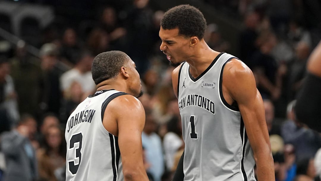 Nov 7, 2025; San Antonio, Texas, USA; San Antonio Spurs forward Victor Wembanyama (1) and San Antonio Spurs forward Keldon Johnson (3) react after gaining the lead at the end of the second quarter against the Houston Rockets at Frost Bank Center.