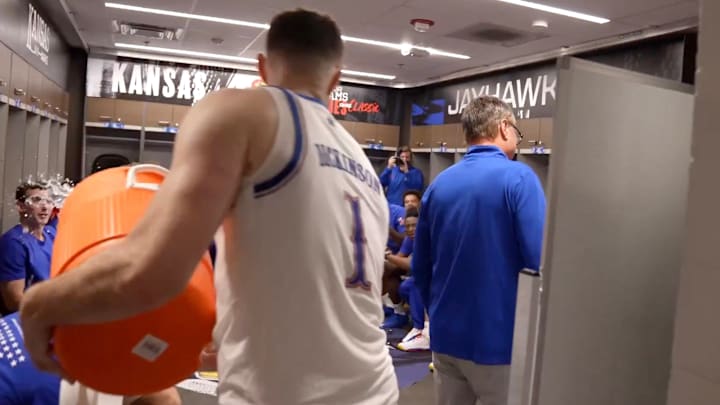 Kansas center Hunter Dickinson tries to shower coach Bill Self with Gatorade in the locker room after a win. Kansas center Hunter Dickinson tries to shower coach Bill Self with Gatorade in the locker room after a win.