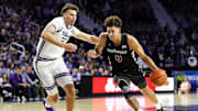 Dec 30, 2024; Manhattan, Kansas, USA; Cincinnati Bearcats guard Dan Skillings Jr. (0) drives against Kansas State Wildcats guard Coleman Hawkins (33) during the first half at Bramlage Coliseum. Mandatory Credit: Jay Biggerstaff-Imagn Images