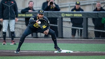 Oregon first baseman Jacob Walsh makes a catch for an out at first as the Oregon Ducks host the Oregon State Beavers on Tuesday, April 30, 2024, at PK Park in Eugene, Ore.