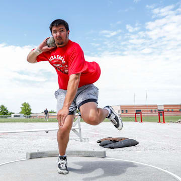 Jackson Cantwell spins around as he practices throwing a shotput during track and field practice at Nixa High School on Wednesday, April 24, 2024. On Friday, Cantwell, the nation's No. 1 football recruit for the Class of 2026, heaved the shot put five feet further than anyone has all season, the No. 2 mark by a junior all-time. 