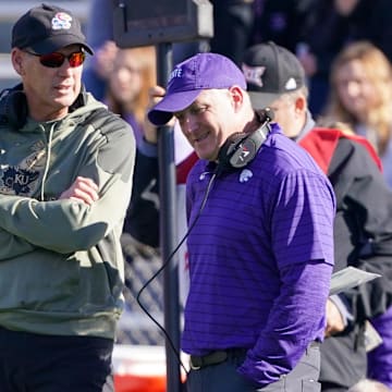 Nov 6, 2021; Lawrence, Kansas, USA; Kansas Jayhawks head coach Lance Leipold (left) talks with Kansas State Wildcats head coach Chris Klieman during an injury time out during the first half at David Booth Kansas Memorial Stadium. Mandatory Credit: Denny Medley-Imagn Images