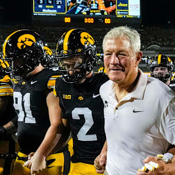 Iowa Hawkeyes head coach Kirk Ferentz runs off the field with his players after becoming the winningest coach in Big Ten history, passing Woody Hayes, with a win over the Massachusetts Minutemen Sept. 13, 2025 at Kinnick Stadium in Iowa City, Iowa.