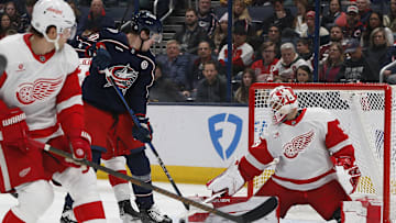 Jan 2, 2025; Columbus, Ohio, USA; Columbus Blue Jackets left wing Dmitri Voronkov (10) tips a puck on goal against the Detroit Red Wings during the first period at Nationwide Arena. Mandatory Credit: Russell LaBounty-Imagn Images