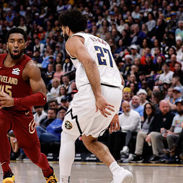 Dec 27, 2024; Denver, Colorado, USA; Cleveland Cavaliers guard Donovan Mitchell (45) controls the ball as Denver Nuggets guard Jamal Murray (27) guards in the first quarter at Ball Arena. Mandatory Credit: Isaiah J. Downing-Imagn Images