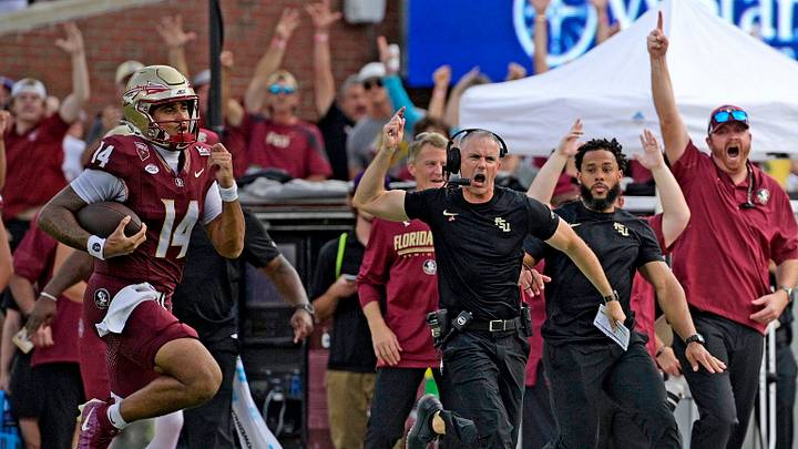 Oct 3, 2026; Tallahassee, Florida, USA;  Florida State Seminoles quarterback Ashton Daniels (14) runs for a touchdown as head coach Mike Norvell cheers on the sidelines during the second half against the Virginia Cavaliers at Doak S. Campbell Stadium.  Mandatory Credit: Melina Myers-Imagn Images