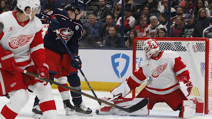 Jan 2, 2025; Columbus, Ohio, USA; Columbus Blue Jackets left wing Dmitri Voronkov (10) tips a puck on goal against the Detroit Red Wings during the first period at Nationwide Arena. Mandatory Credit: Russell LaBounty-Imagn Images