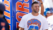 Former Florida Gators quarterback Tim Tebow watches team intros against the Miami Hurricanes before the NCAA football game