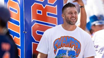Aug 31, 2024; Gainesville, Florida, USA; Former Florida Gators quarterback Tim Tebow (15) watches team introductions against the Miami Hurricanes before the game at Ben Hill Griffin Stadium. Mandatory Credit: Matt Pendleton-Imagn Images