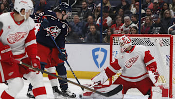 Jan 2, 2025; Columbus, Ohio, USA; Columbus Blue Jackets left wing Dmitri Voronkov (10) tips a puck on goal against the Detroit Red Wings during the first period at Nationwide Arena. Mandatory Credit: Russell LaBounty-Imagn Images