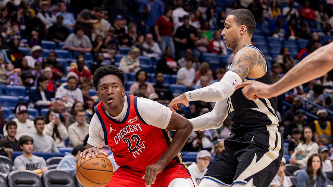 Feb 20, 2026; New Orleans, Louisiana, USA;  New Orleans Pelicans center Derik Queen (22) dribbles against Milwaukee Bucks forward Kyle Kuzma (18) during the second half at Smoothie King Center. Mandatory Credit: Stephen Lew-Imagn Images