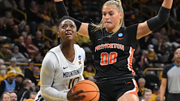 Mar 23, 2024; Iowa City, IA, USA; West Virginia Mountaineers guard Jordan Harrison (10) goes to the basket as Princeton Tigers forward Ellie Mitchell (00) defends during the first quarter of the NCAA first round game at Carver-Hawkeye Arena. Mandatory Credit: Jeffrey Becker-Imagn Images