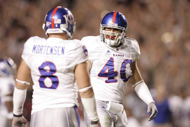 Kansas Jayhawks linebacker Mike Rivera (40 talks with linebacker Joe Mortensen (8) against the Texas A&M Aggies.