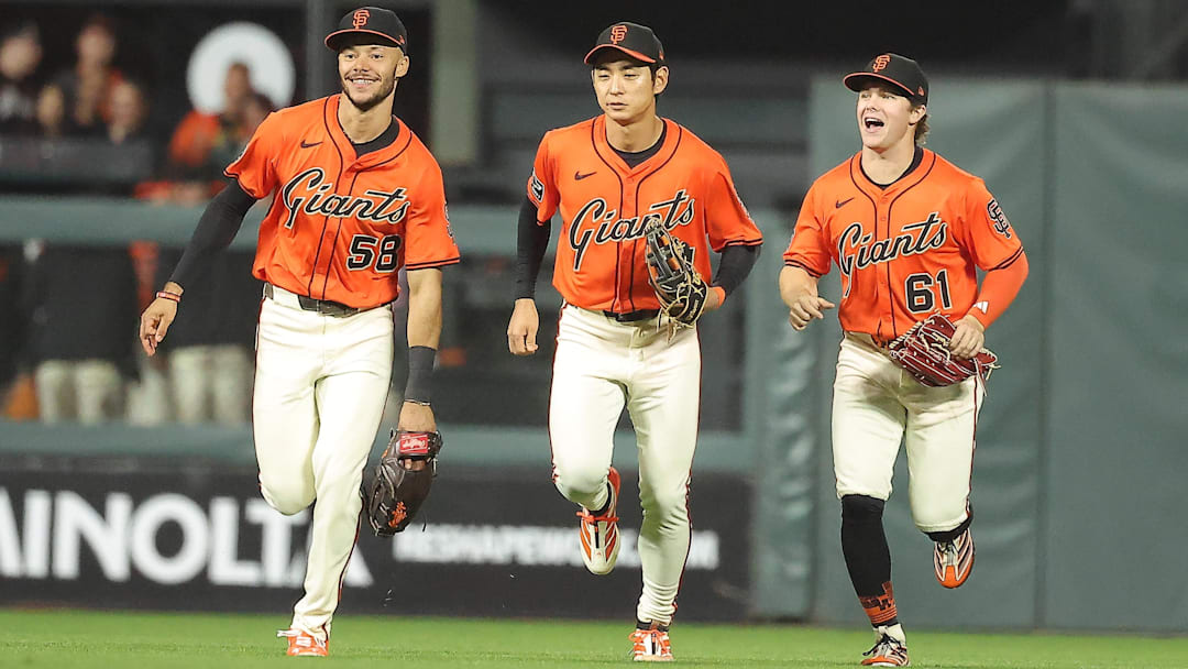 Sep 26, 2025; San Francisco, California, USA; against the San Francisco Giants outfielders jog infield after the game against the Colorado Rockies at Oracle Park. Mandatory Credit: Kelley L Cox-Imagn Images