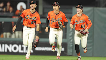 Sep 26, 2025; San Francisco, California, USA; against the San Francisco Giants outfielders jog infield after the game against the Colorado Rockies at Oracle Park. Mandatory Credit: Kelley L Cox-Imagn Images