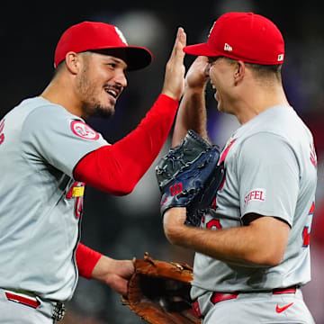 Sep 25, 2024; Denver, Colorado, USA; St. Louis Cardinals third base Nolan Arenado (28) and relief pitcher Ryan Helsley (56) celebrate defeating the Colorado Rockies at Coors Field. Mandatory Credit: Ron Chenoy-Imagn Images