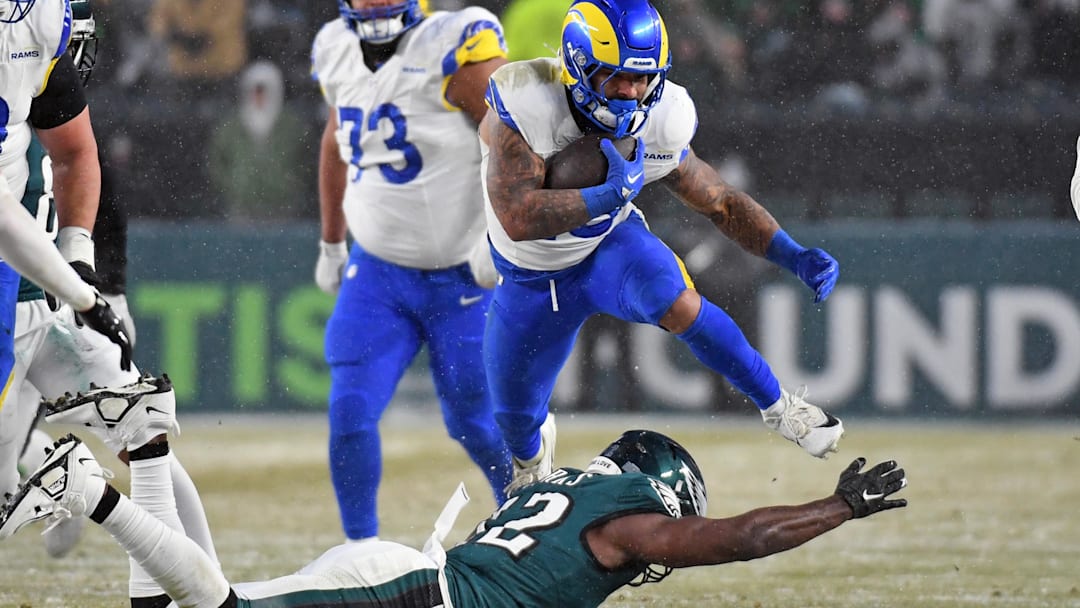 Jan 19, 2025; Philadelphia, Pennsylvania, USA; Los Angeles Rams running back Kyren Williams (23) leaps over Philadelphia Eagles linebacker Oren Burks (42) during the third quarter against the Philadelphia Eagles in a 2025 NFC divisional round game at Lincoln Financial Field. Mandatory Credit: Eric Hartline-Imagn Images