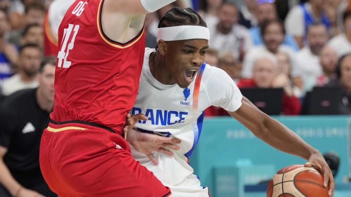 Aug 2, 2024; Villeneuve-d'Ascq, France; France small forward Bilal Coulibaly (99) controls the ball against Germany shooting guard Andreas Obst (42) in the second half in a men’s group B basketball game during the Paris 2024 Olympic Summer Games at Stade Pierre-Mauroy. Mandatory Credit: John David Mercer-USA TODAY Sports