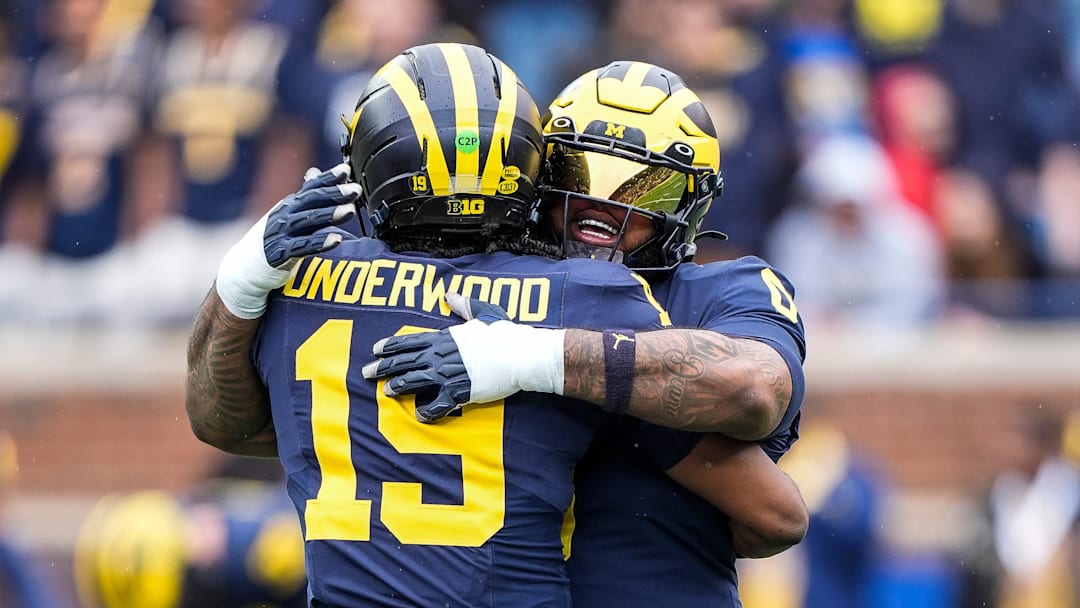 Michigan quarterback Bryce Underwood (19) hugs defensive lineman Tré Williams (0) before the first half of the spring game at Michigan Stadium in Ann Arbor on Saturday, April 19, 2025.