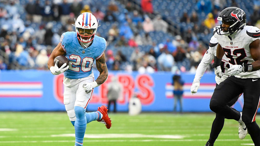 Jan 5, 2025; Nashville, Tennessee, USA;  Tennessee Titans running back Tony Pollard (20) runs the ball against the Houston Texans during the first half at Nissan Stadium. Mandatory Credit: Steve Roberts-Imagn Images