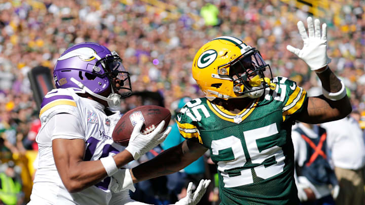 Minnesota Vikings wide receiver Justin Jefferson (18) catches a touchdown pass against Green Bay Packers cornerback Keisean Nixon (25) in the second quarter during their football game Sunday, September 29, 2024, at Lambeau Field in Green Bay, Wisconsin.