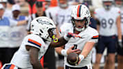 Nov 15, 2025; Durham, North Carolina, USA;  Virginia Cavaliers quarter back Chandler Morris (4) hands the ball to Virginia Cavaliers running back J'Mari Taylor (3) during the first quarter against the Duke Blue Devils at Wallace Wade Stadium. Mandatory Credit: Zachary Taft-Imagn Images