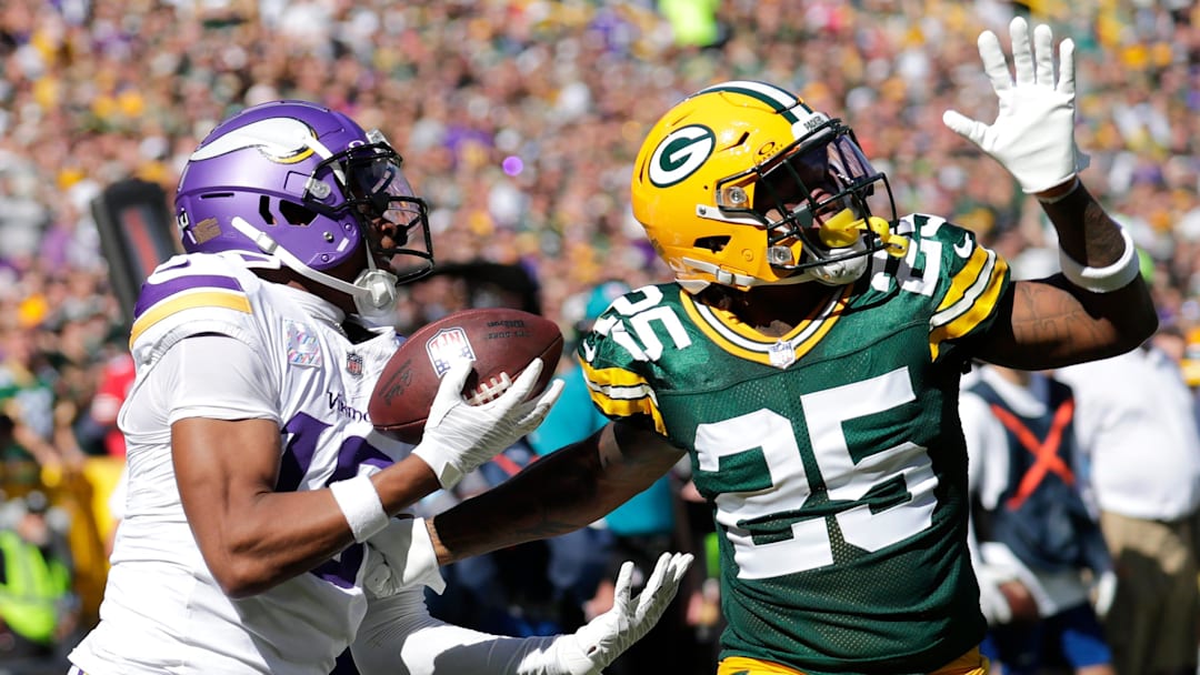 Minnesota Vikings wide receiver Justin Jefferson (18) catches a touchdown pass against Green Bay Packers cornerback Keisean Nixon (25) in the second quarter during their football game Sunday, September 29, 2024, at Lambeau Field in Green Bay, Wisconsin.