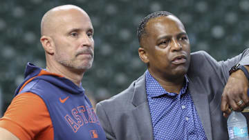Jun 28, 2025; Houston, Texas, USA; Houston Astros manager Joe Espada (left) and general manager Dana Brown (right) talk on the field before the game against the Chicago Cubs at Daikin Park.