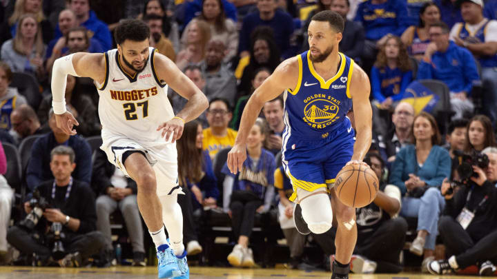 Feb 25, 2024; San Francisco, California, USA; Denver Nuggets guard Jamal Murray (27) chases Golden State Warriors guard Stephen Curry (30) as he brings the ball up court during the second quarter at Chase Center. Mandatory Credit: D. Ross Cameron-USA TODAY Sports