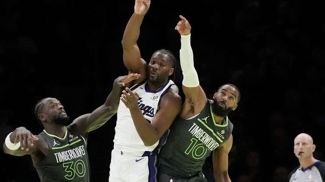 Nov 14, 2025; Minneapolis, Minnesota, USA; Sacramento Kings forward Precious Achiuwa (9) passes the ball between Minnesota Timberwolves forward Julius Randle (30) and guard Mike Conley (10) in the first quarter at Target Center. Mandatory Credit: Bruce Kluckhohn-Imagn Images