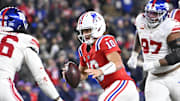 Dec 1, 2025; Foxborough, Massachusetts, USA; New England Patriots quarterback Drake Maye (10) runs the ball against New York Giants linebacker Zaire Barnes (46) during the fourth quarter at Gillette Stadium. Mandatory Credit: Eric Canha-Imagn Images