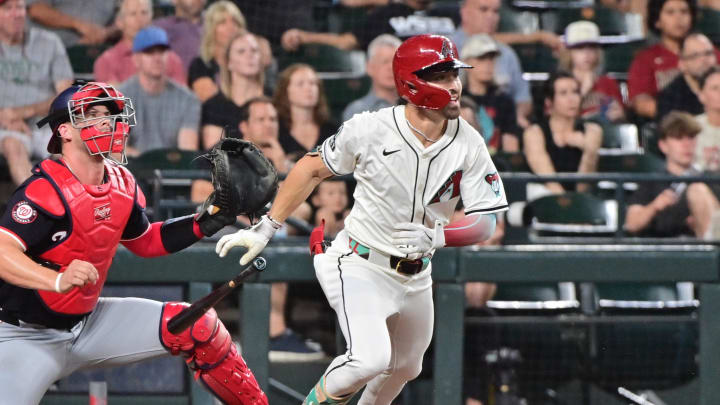 Jul 31, 2024; Phoenix, Arizona, USA;  Arizona Diamondbacks outfielder Corbin Carroll (7) hits an RBI single against the Washington Nationals in the sixth inning at Chase Field. Mandatory Credit: Matt Kartozian-USA TODAY Sports